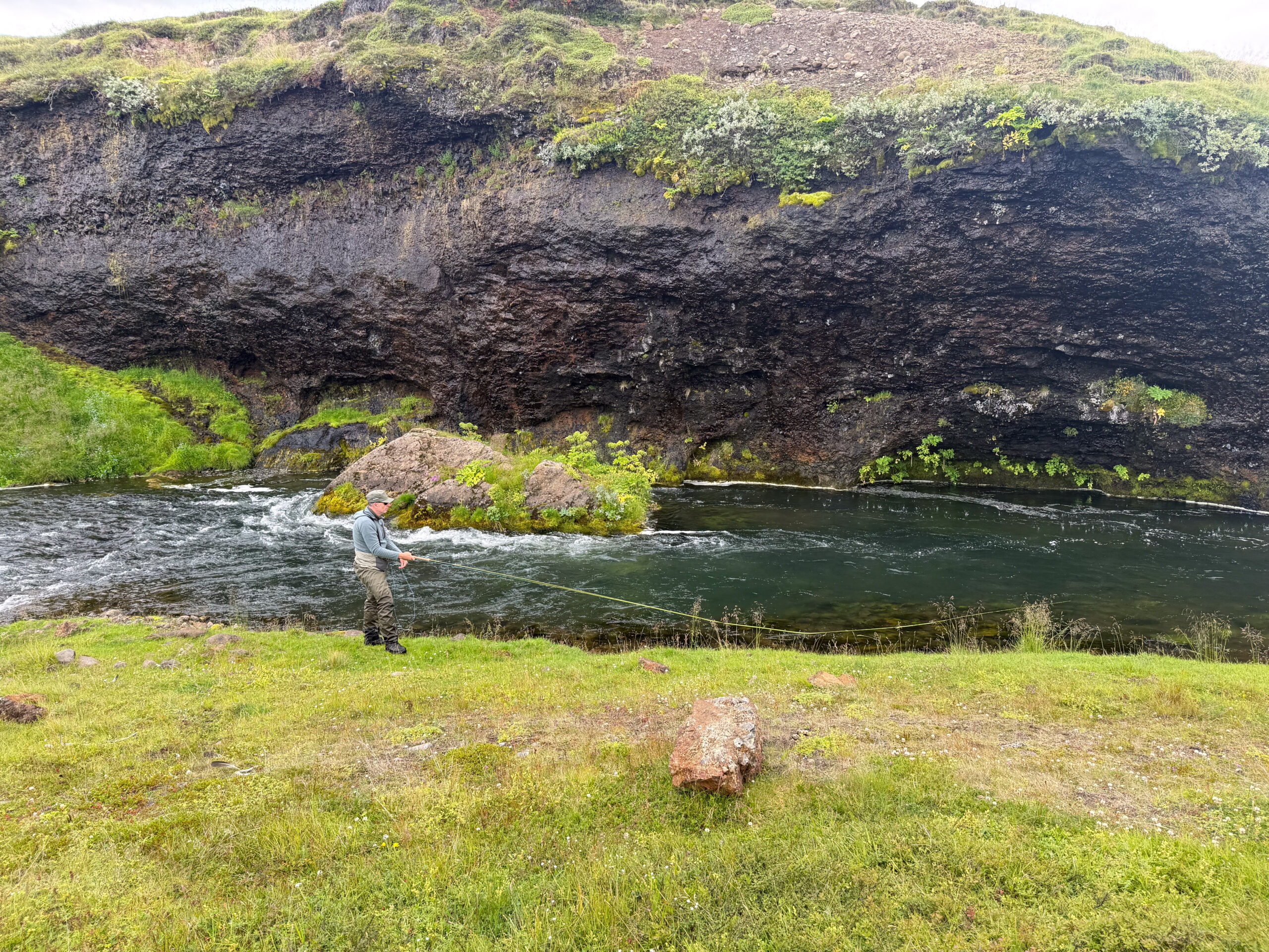 angler fishing a beautyful canyon pool on river Mýrarkvísl